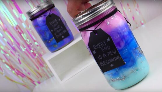 Silver glitter, cotton, and acrylic paints inside mason jars